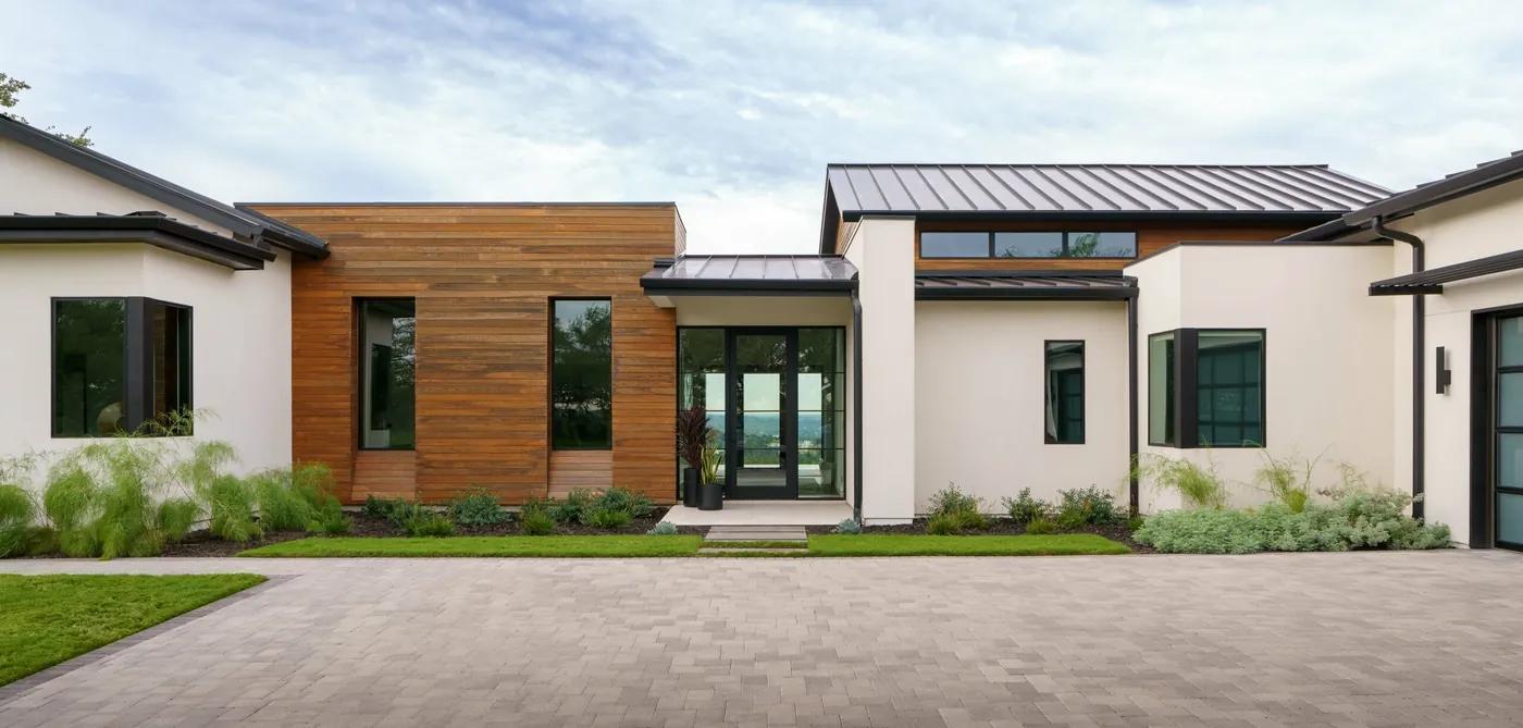 Modern wood-and-stucco Hill Country home with hand-laid paver entry court